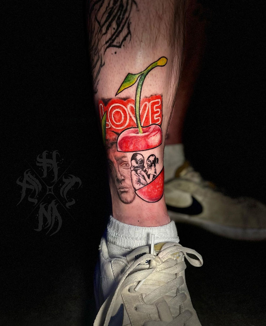 Color cherry and lettering tattoo on the leg