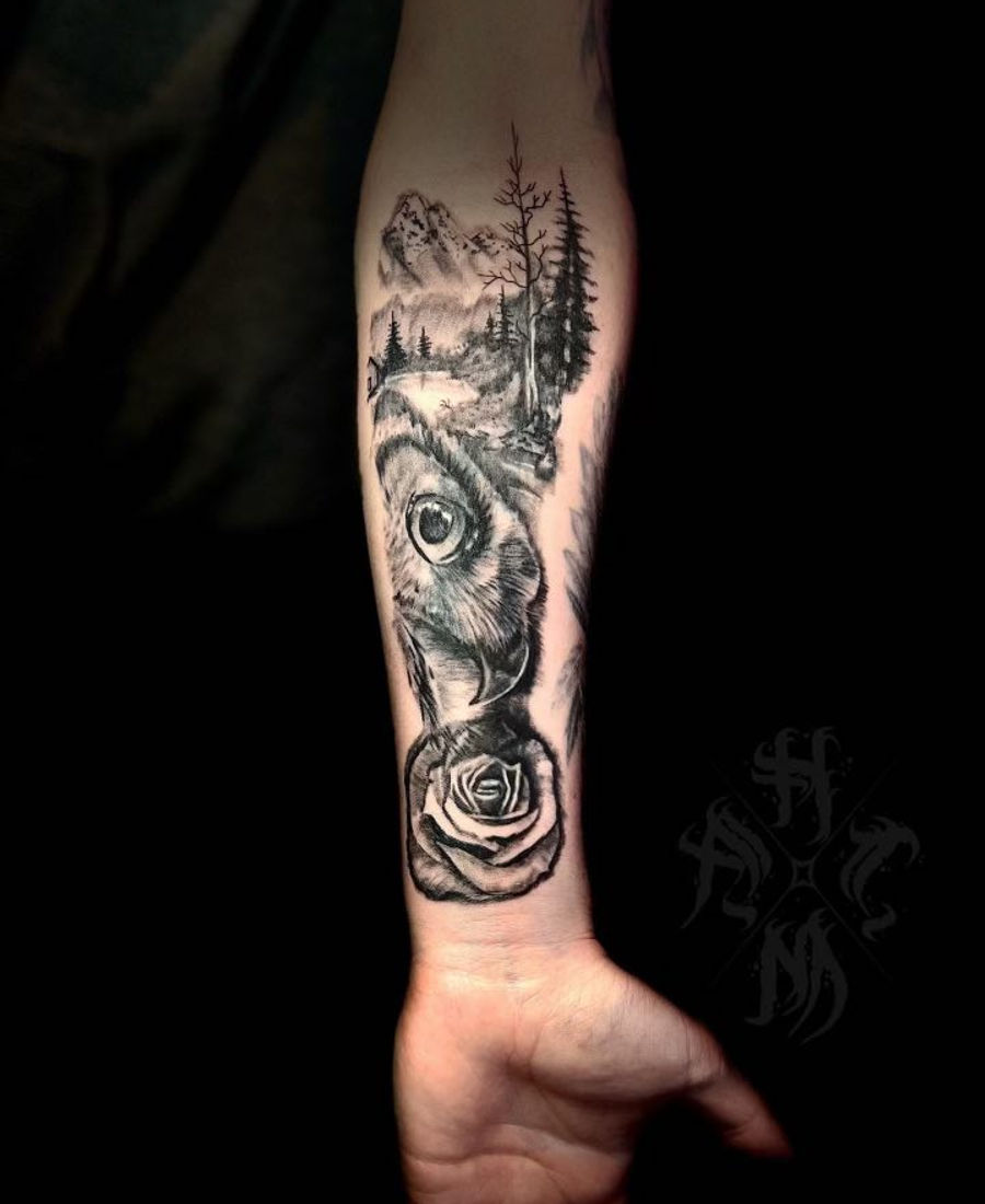 Black and grey wolf and mountain landscape forearm
