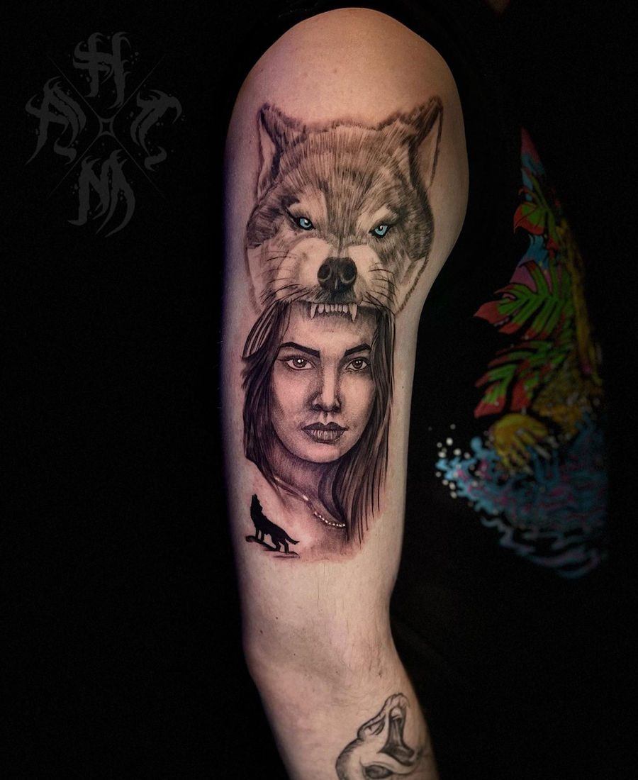Black and grey portrait sleeve of a woman with a wolf headdress, tattooed at 4MileZ