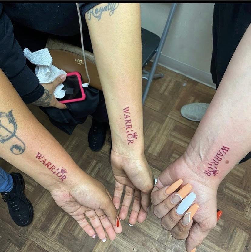 Matching warrior script wrist tattoos