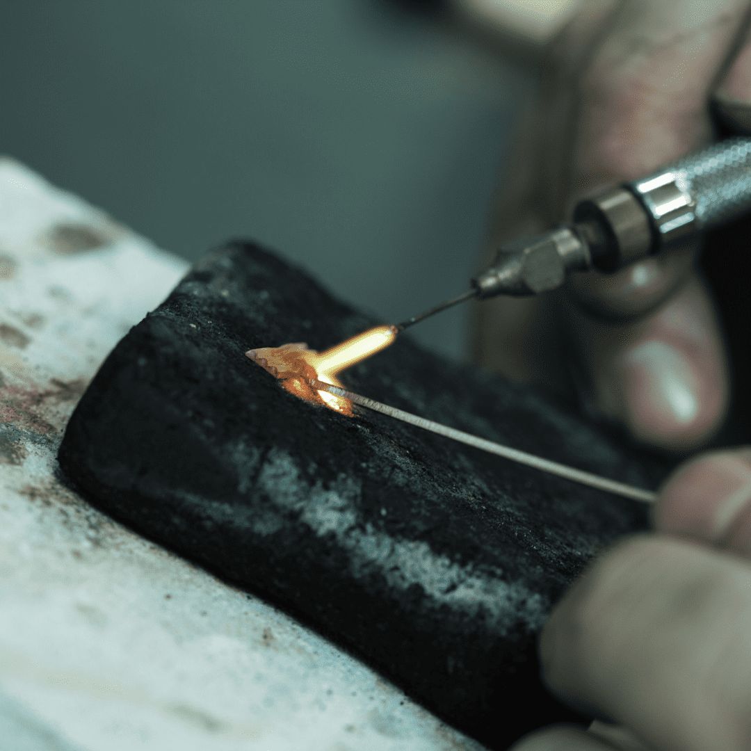 Soldering a piece at the bench