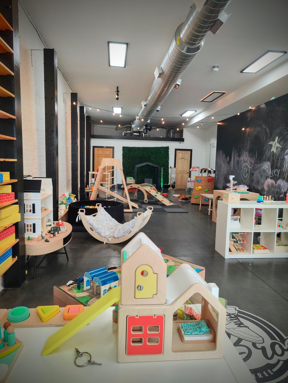 Children's wooden climbing structures and play areas inside Green Elephant