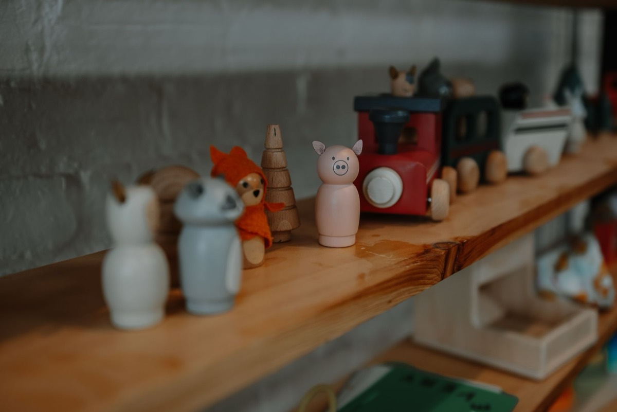 Close up of small wooden figures on a shelf