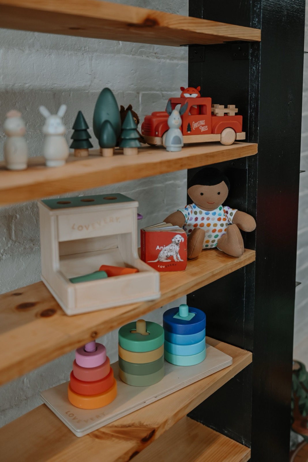 Natural wooden toys arranged on pine shelves