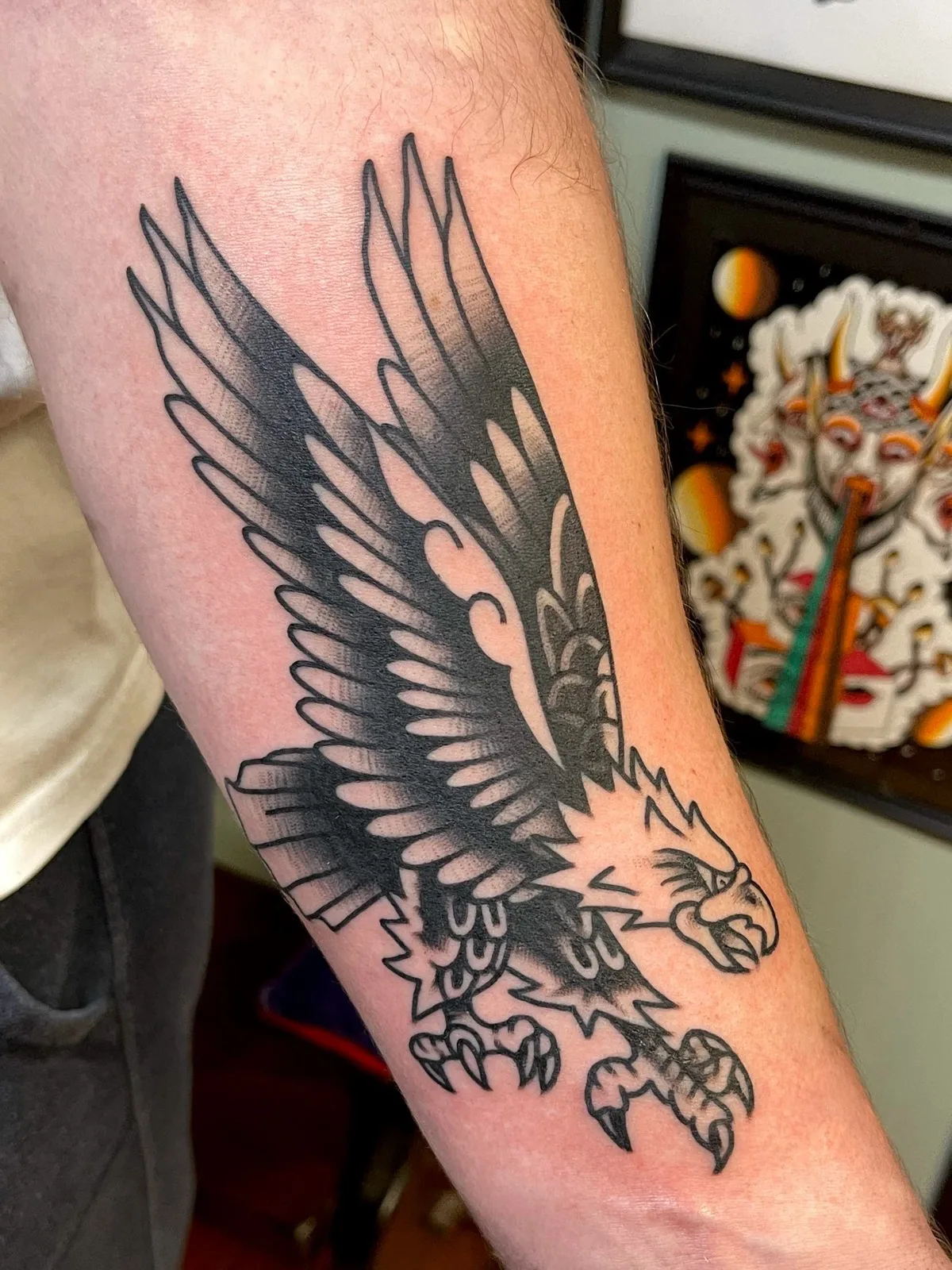 American traditional black-and-grey eagle tattoo on a forearm at Horseshoes and Hand Grenades Tattoo, Chicopee MA