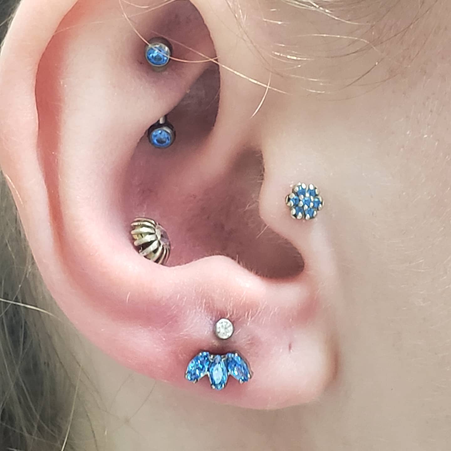 Curated ear with blue gem cluster and lotus