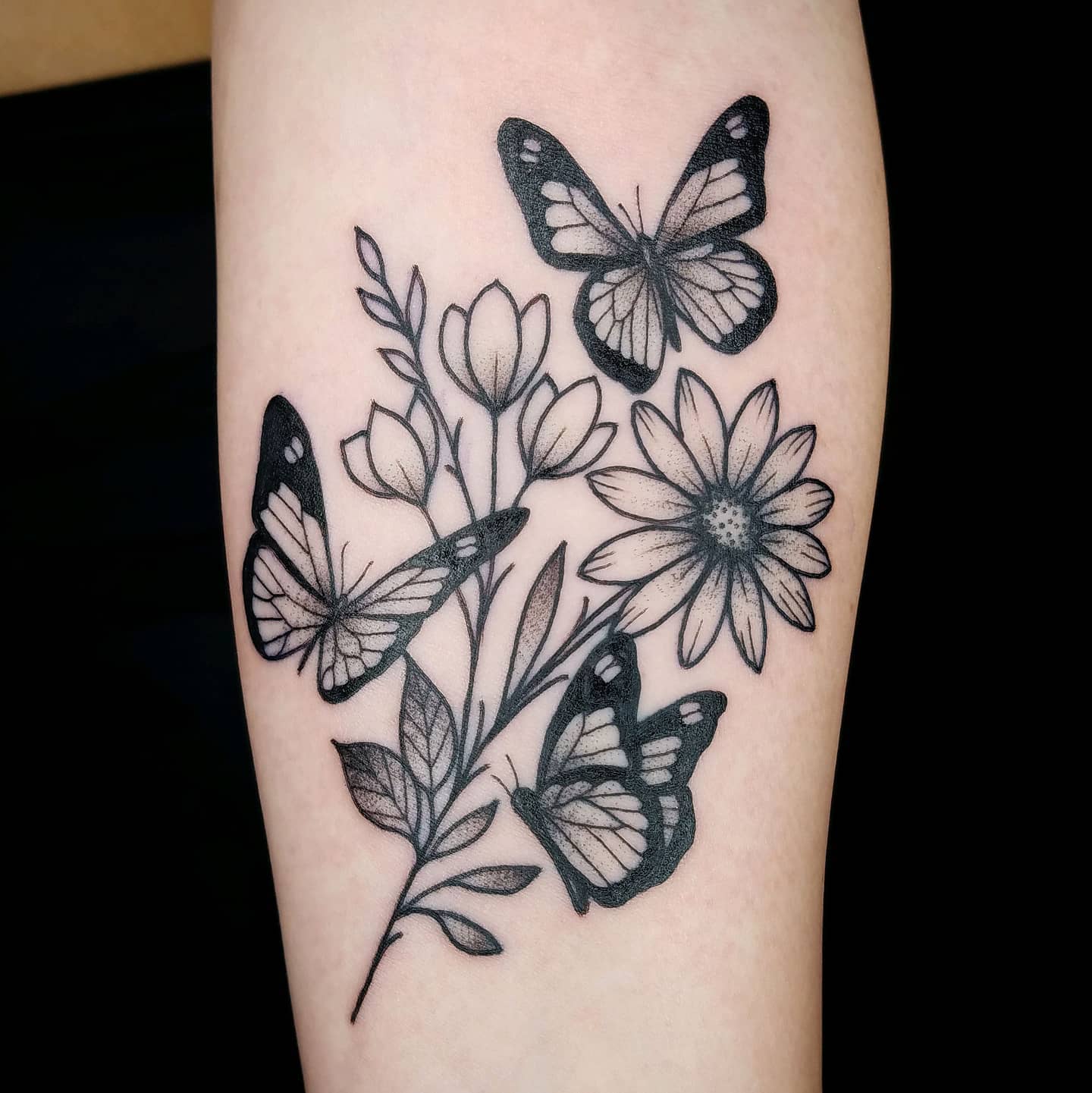 Fine black-and-grey butterflies and wildflowers tattoo